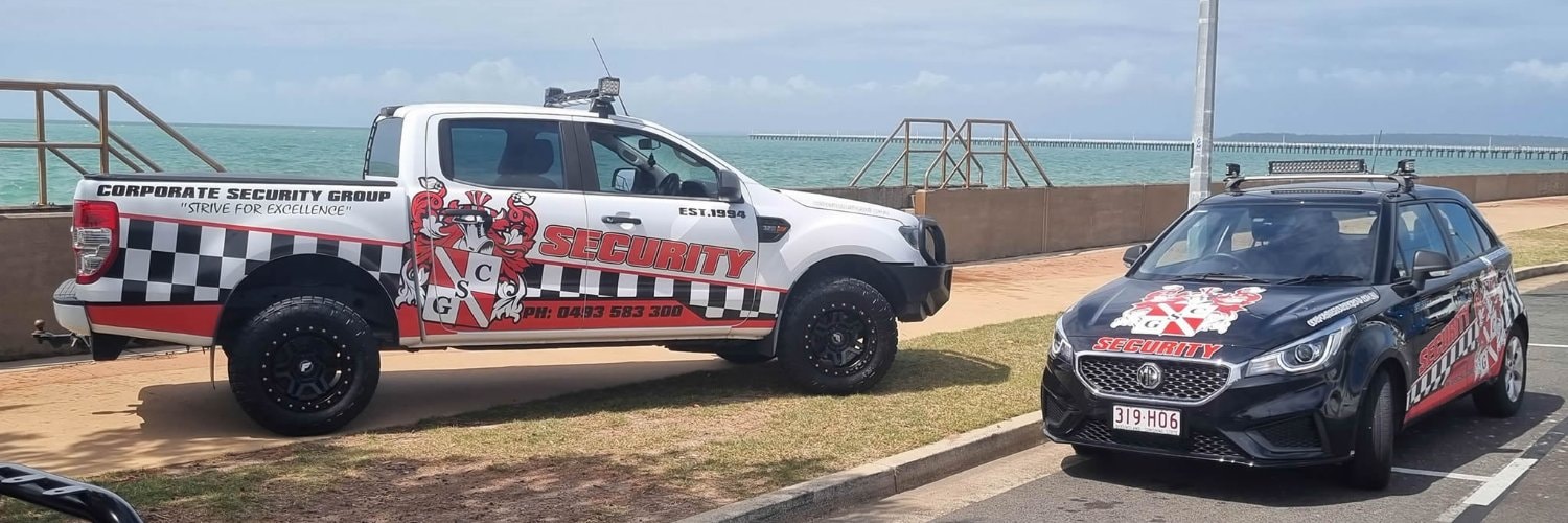 Two Corporate Security Group branded patrol vehicles parked at Hervey Bay waterfront — Ford Ranger ute and MG sedan with red, white and black livery