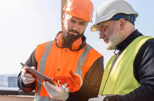 Construction workers discussing project plans on site