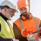 Construction Site Security Construction workers discussing project plans on site
